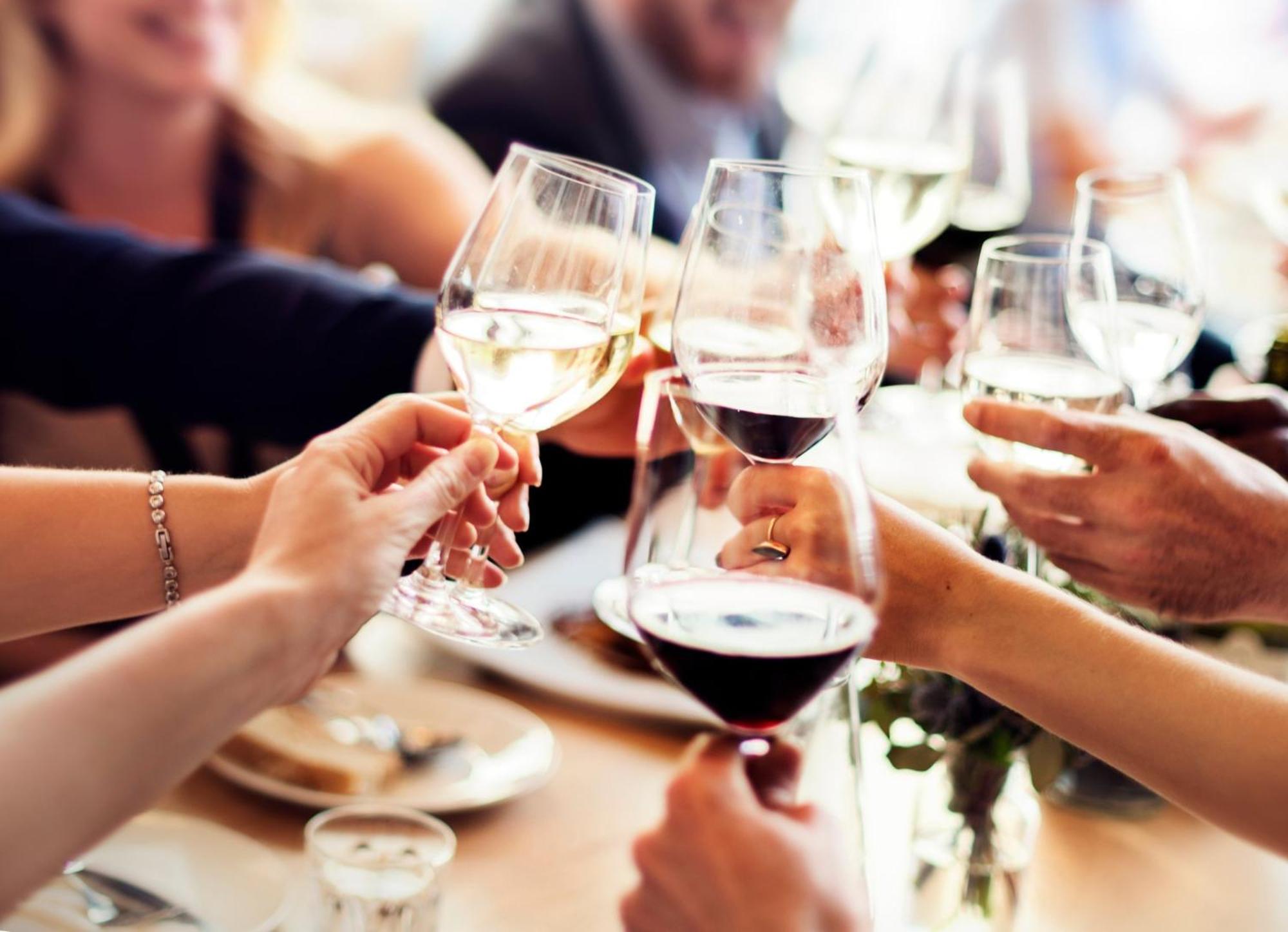 Crowne Plaza Changi Airport By Ihg Сингапур Экстерьер фото The photo shows a group of people celebrating, as indicated by the clinking of wine glasses. Several hands are holding various types of glasses filled with different beverages, including red wine and white wine. In the background, other people are ga